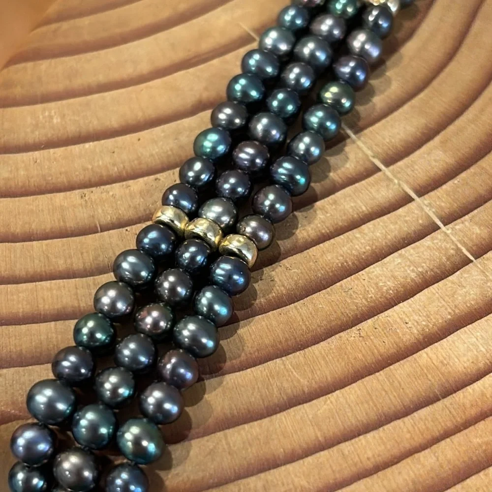 Tahitian black pearl bracelet with 14k gold filigree clasp.